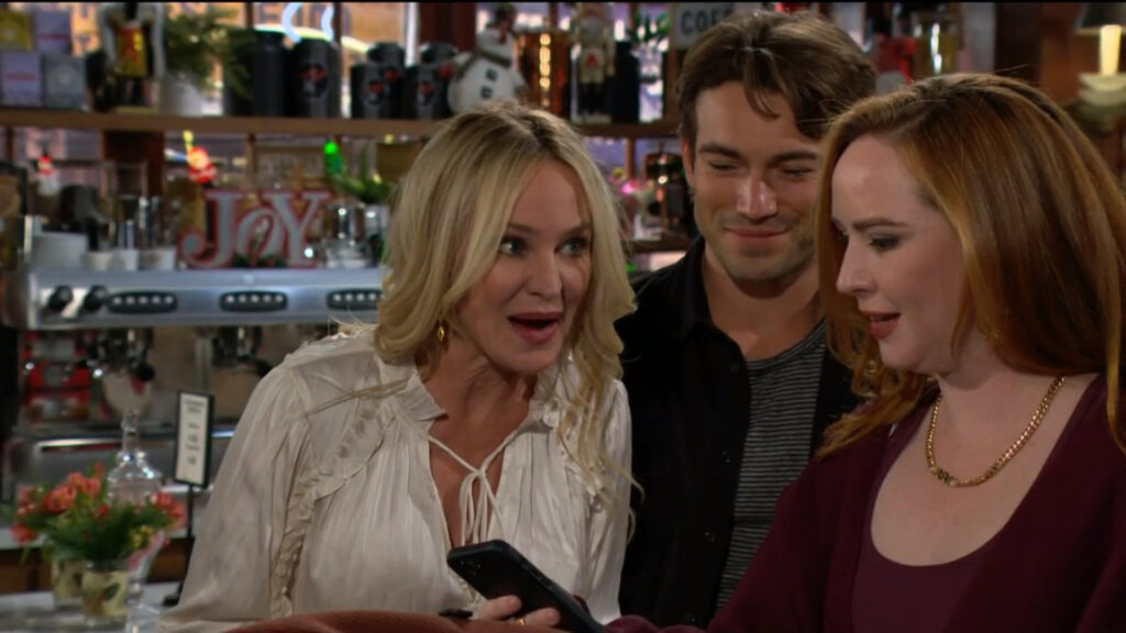 Mariah shows her phone to Sharon, Noah, and Tessa
