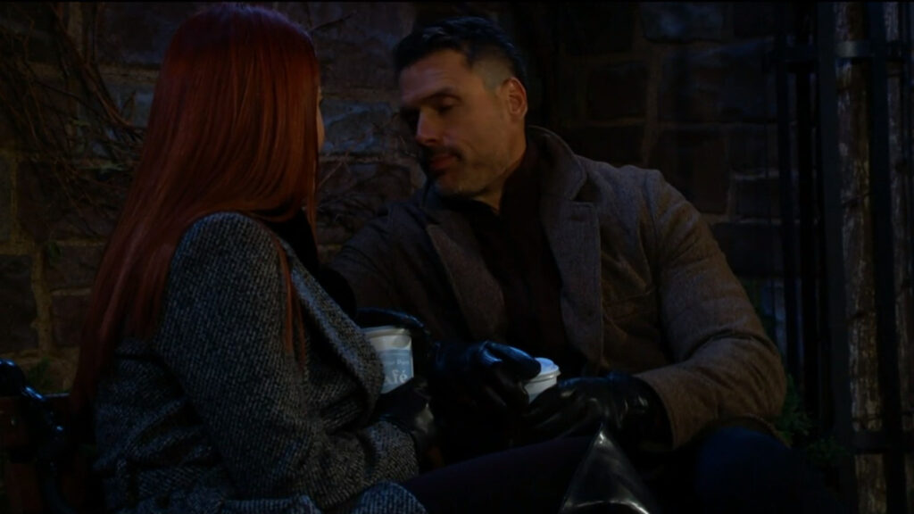 Nick and Sally sit on a bench drinking hot drinks in Chancellor Park. It's dark out.  - Young and The Restless Recap for Dec 22
