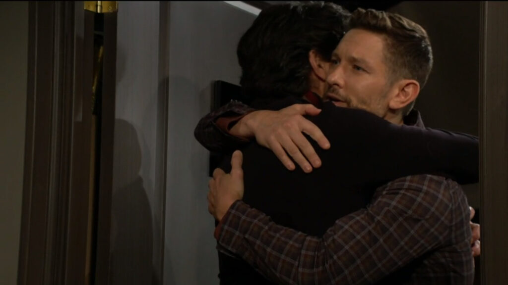 Daniel hugs his father, Danny, in the doorway to Danny's hotel room