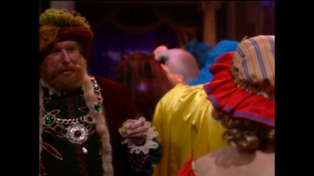 Douglas Austin, dressed as King Henry VIII, talks with someone disguised as Little Bo Peep