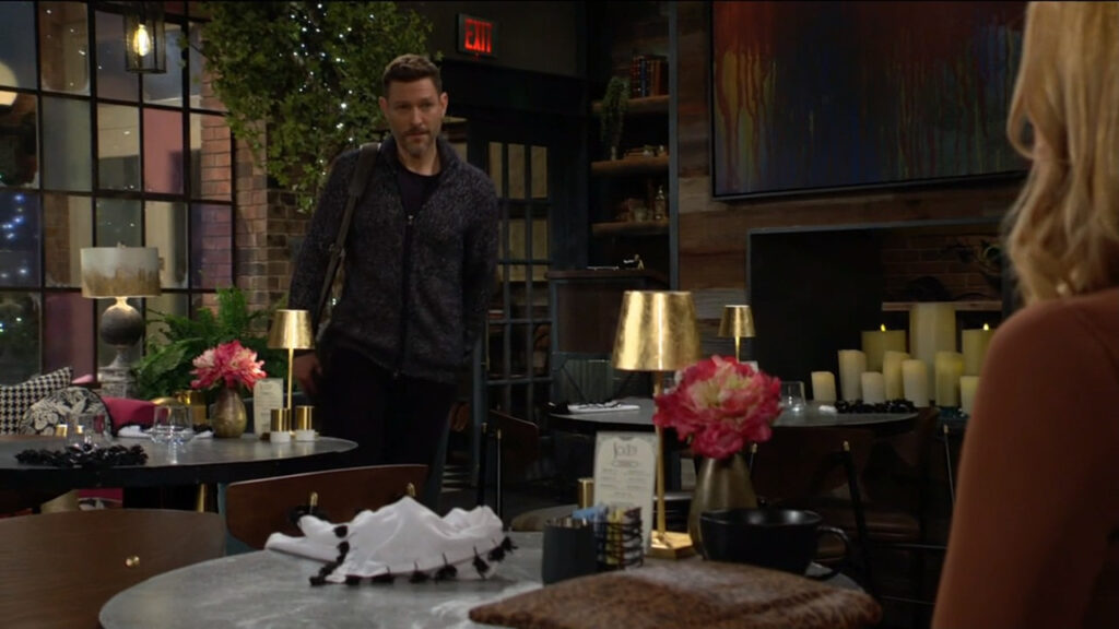 Jeremy leaves Phyllis at the table and passes Daniel, who's on his way in to see Phyllis