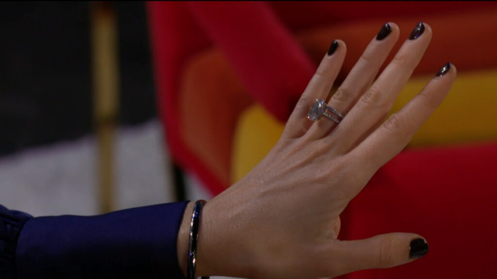 Abby looks down at her wedding ring