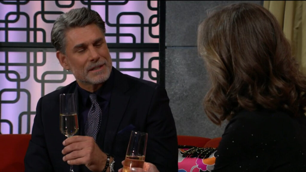 Jeremy and Diane have a drink of champagne together while they sit and talk