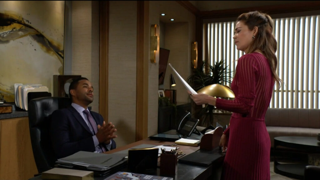 Victoria looks over Audra's resume as Nate leans back in his office chair behind his desk