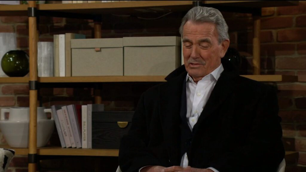 Victor Newman smiles as he sits and talks with Chelsea