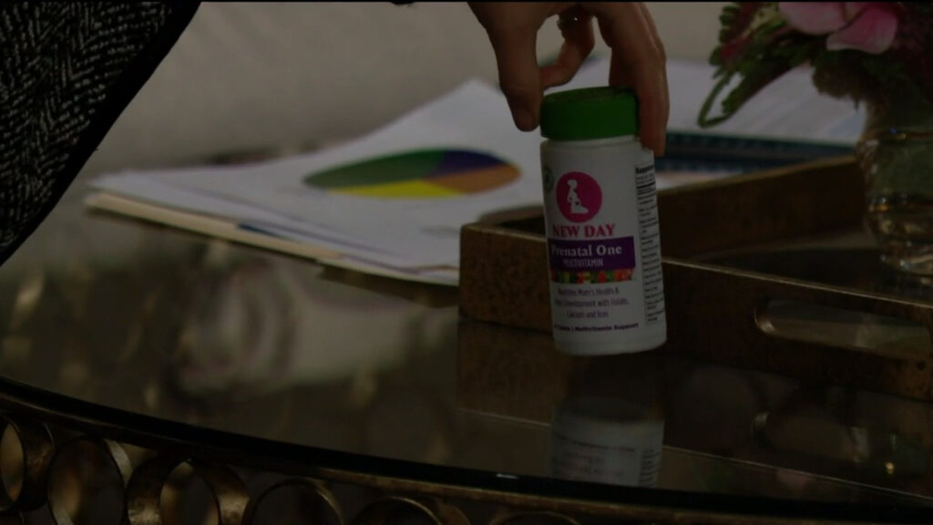 Chloe leaves a bottle of neonatal vitamins on Sally's coffee table