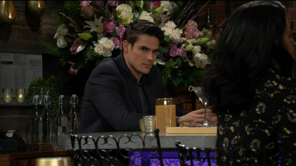 Adam sits at the bar and watches Sally and Nick talk