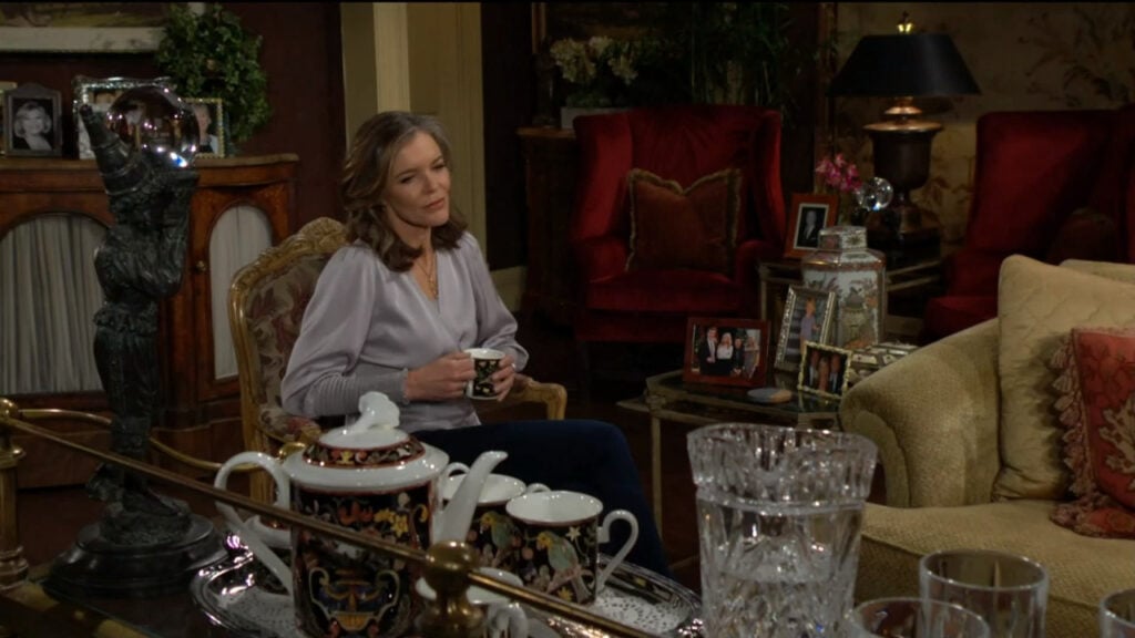 Diane sits in a chair with a cup of tea, smiling as she recalls her time with Jack