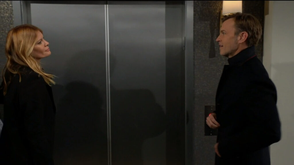 Tucker and Phyllis talk while they wait for an elevator in the hotel lobby