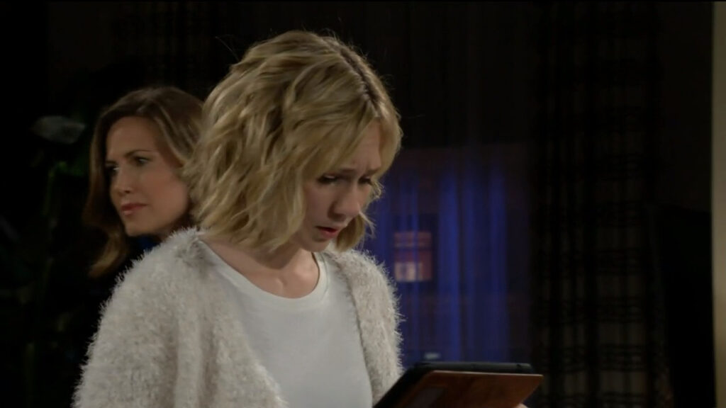 Lucy looks at the tablet that Daniel handed her