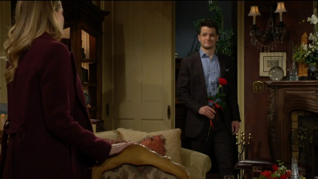 Kyle is smiling and holding a rose as he invites Summer to have lunch with him.