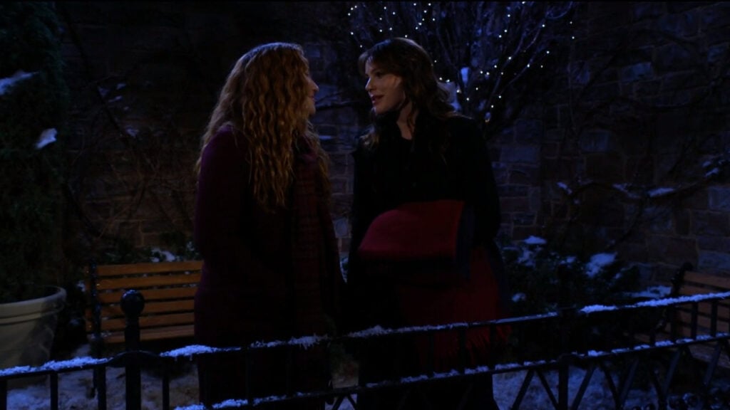 Tessa speaks to Mariah as they stand in the cold, dark park