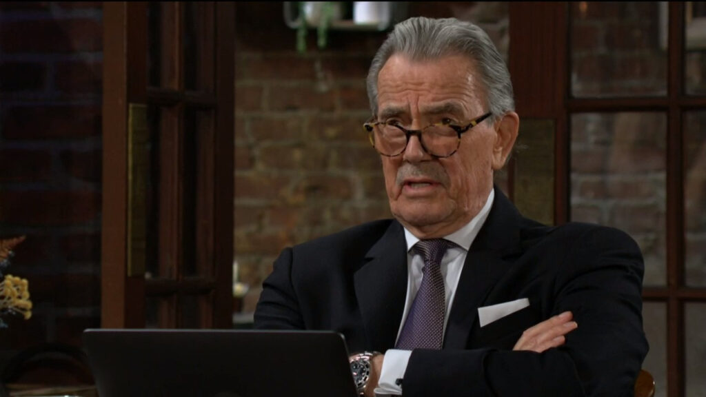 Victor Newman is sitting in the coffee shop in front of a laptop as he talks with Jeremy Stark