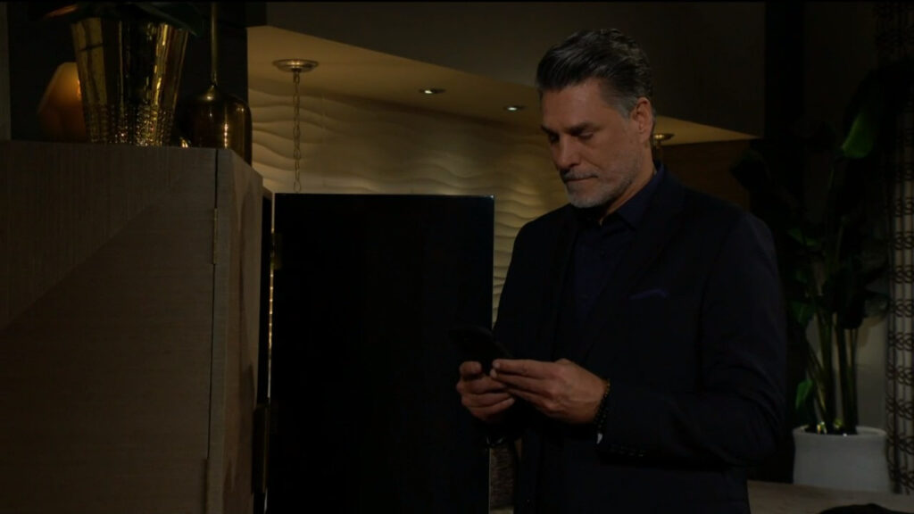 Jeremy looks at his phone as he speaks with Phyllis
