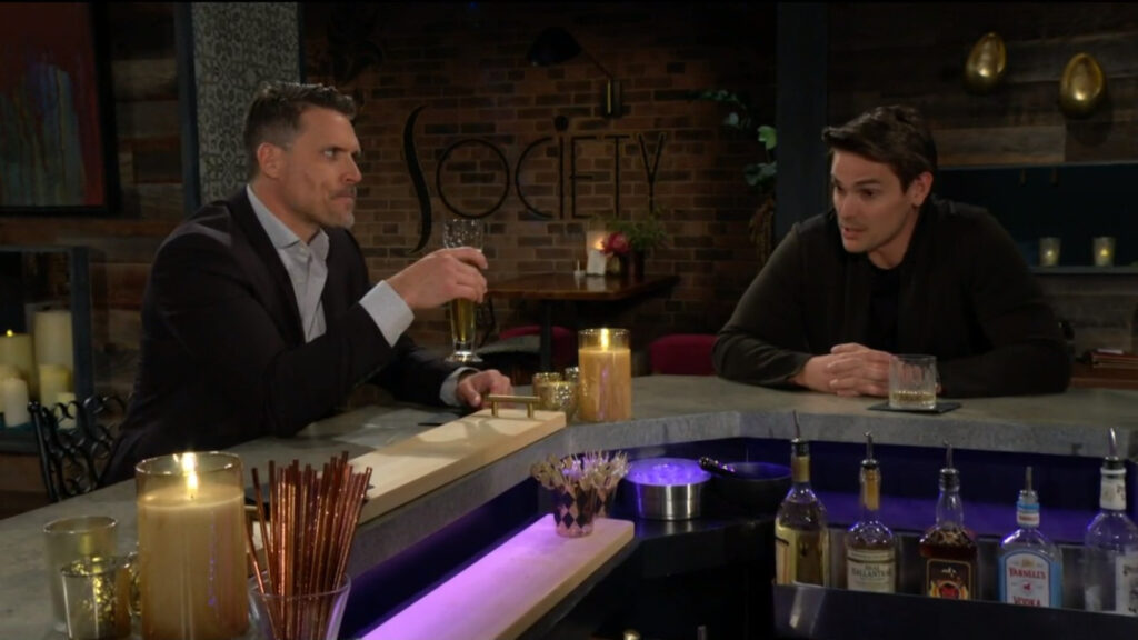 Nick and Adam sit at the bar and have drinks while they talk