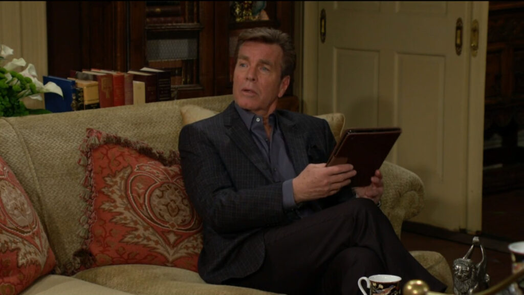 Jack sits on the couch reading a tablet when Diane comes into the room