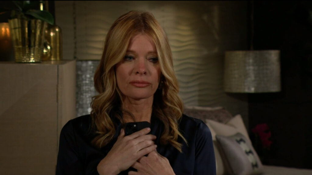 Phyllis holds her phone with tears in her eyes