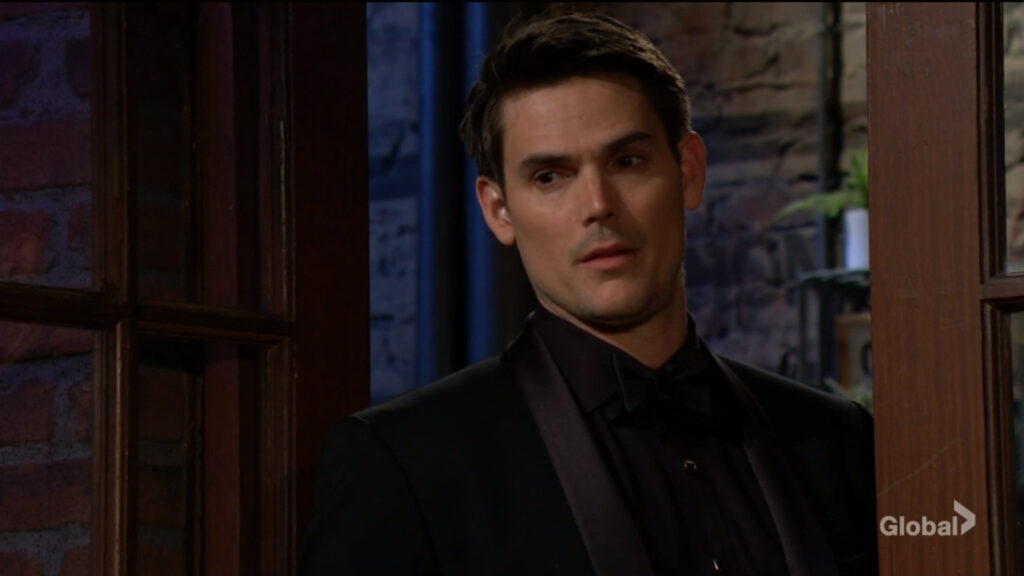 Adam stands in the doorway of the cafe and talks with Nick and Sally