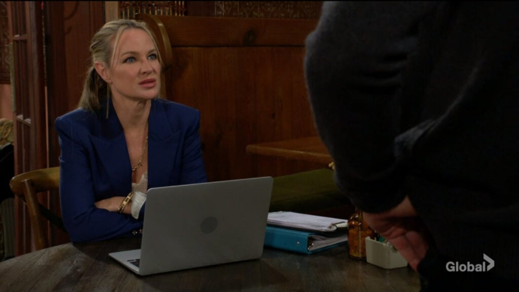 Sharon sits in front of her laptop while she talks with Billy