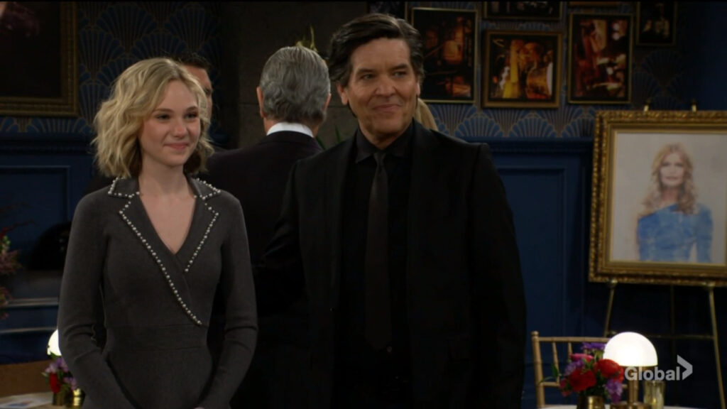 Lucy smiles at Daniel as she stands beside Danny