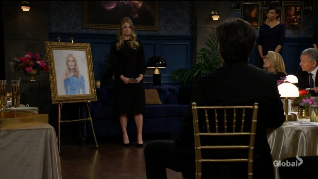 Summer stands in front of Phyllis's portrait