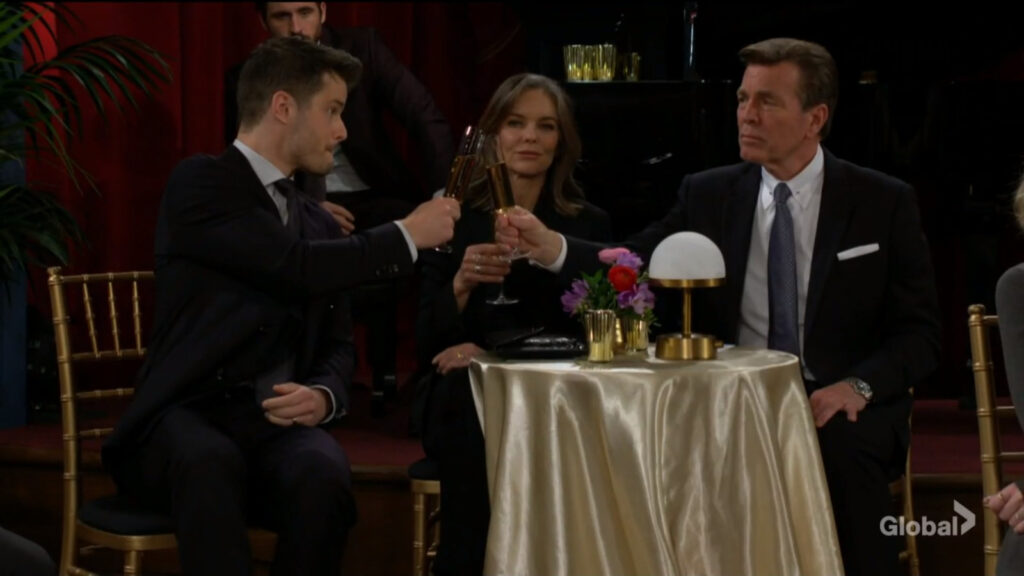 Kyle, Diane, and Jack raise their glasses in a toast
