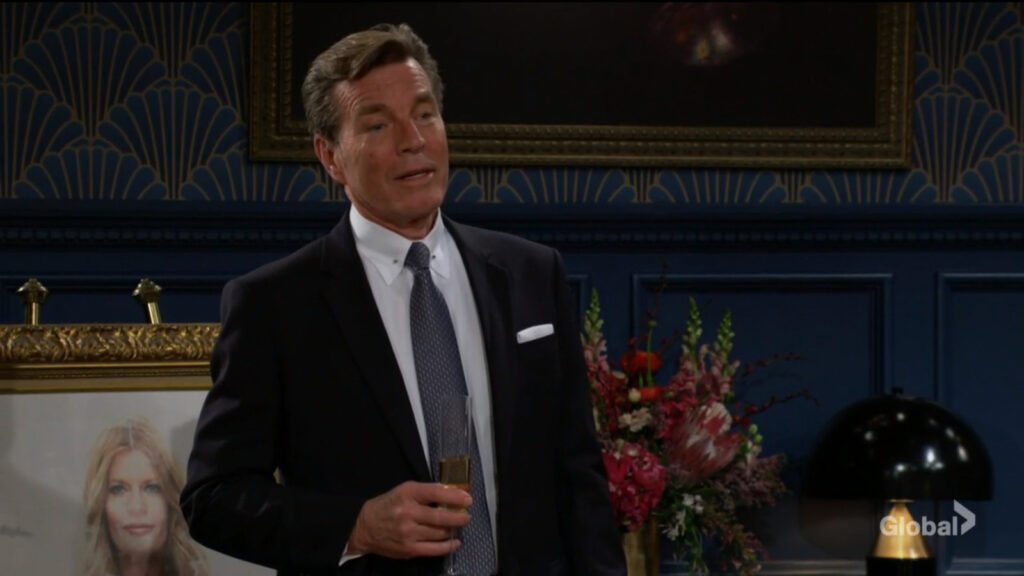 Jack stands with a drink in his hand in front of Phyllis's portrait