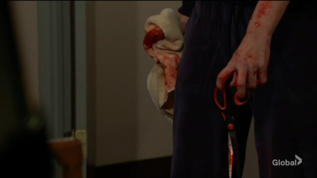 Phyllis holds a pair of bloody scissors