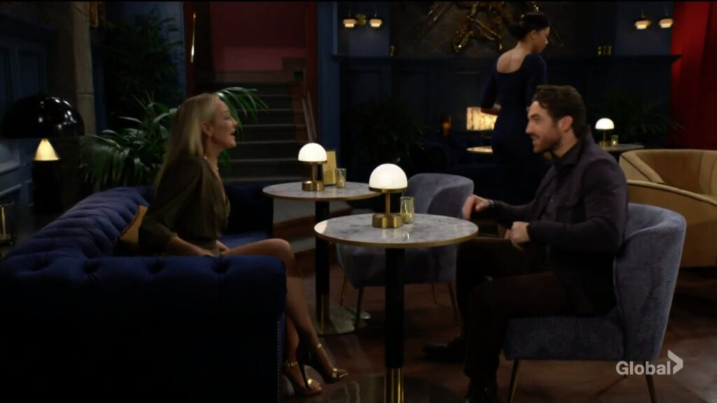 Chance and Sharon sit at a table in the lounge and talk.