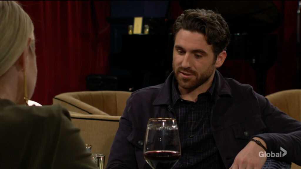 Chance smiles as he sits with a glass of wine in front of him as he talks with Sharon.