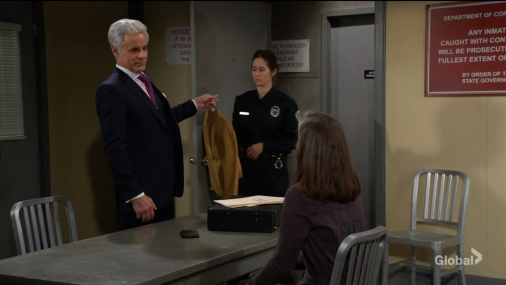 Michael holds Diane's clothes as he calls for a guard.
