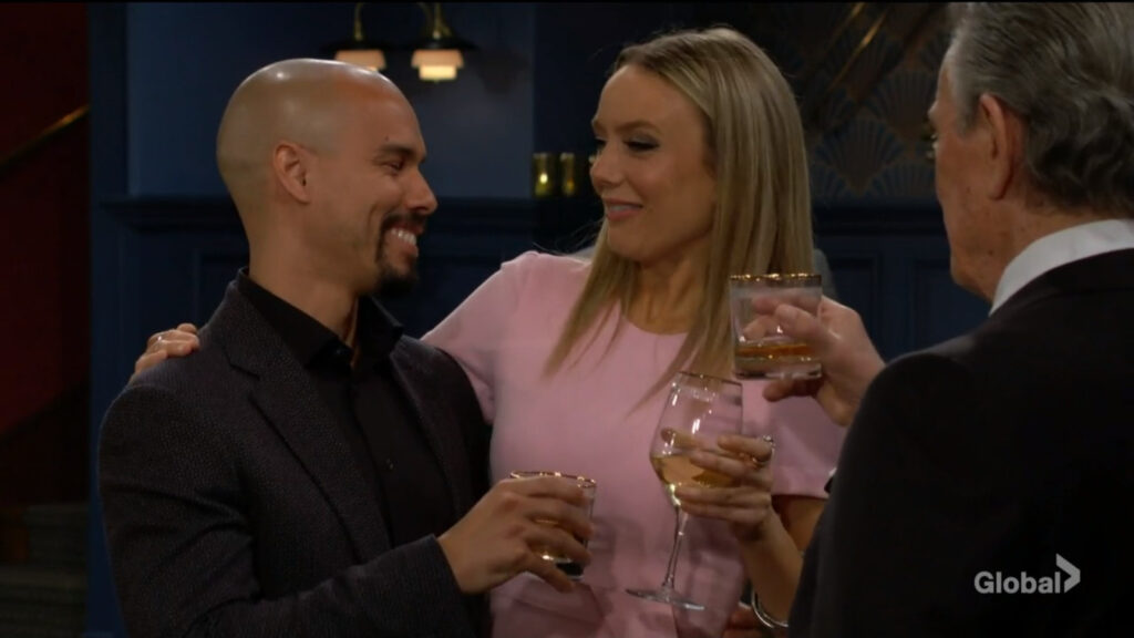 Devon, Abby, and Victor raise their glasses in a toast.