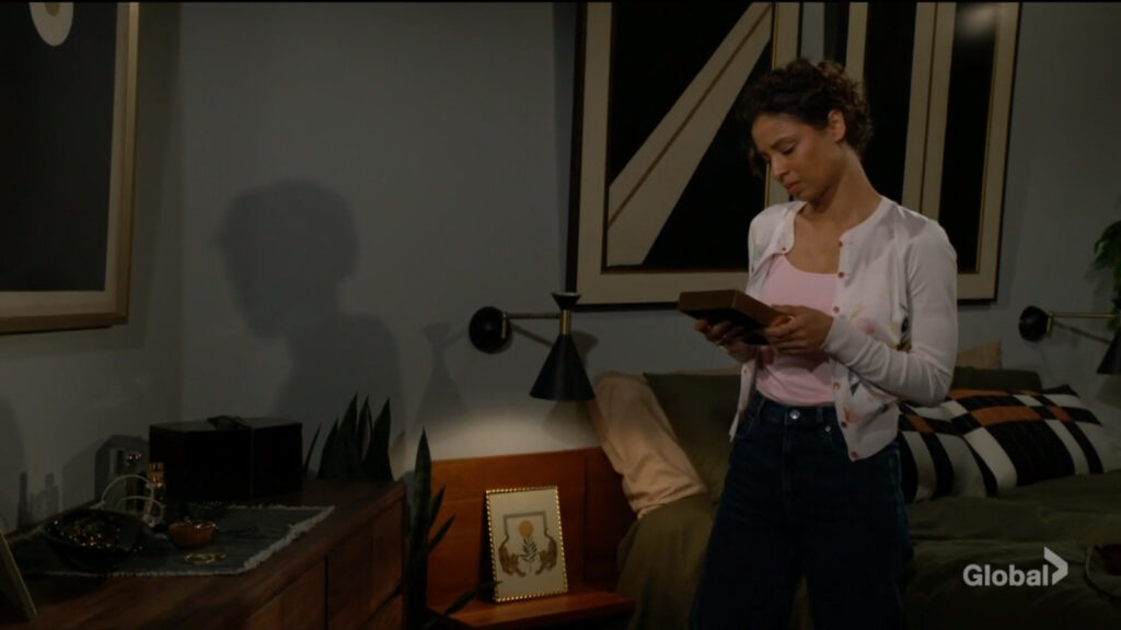 Elena looks at a picture of her and Nate together.