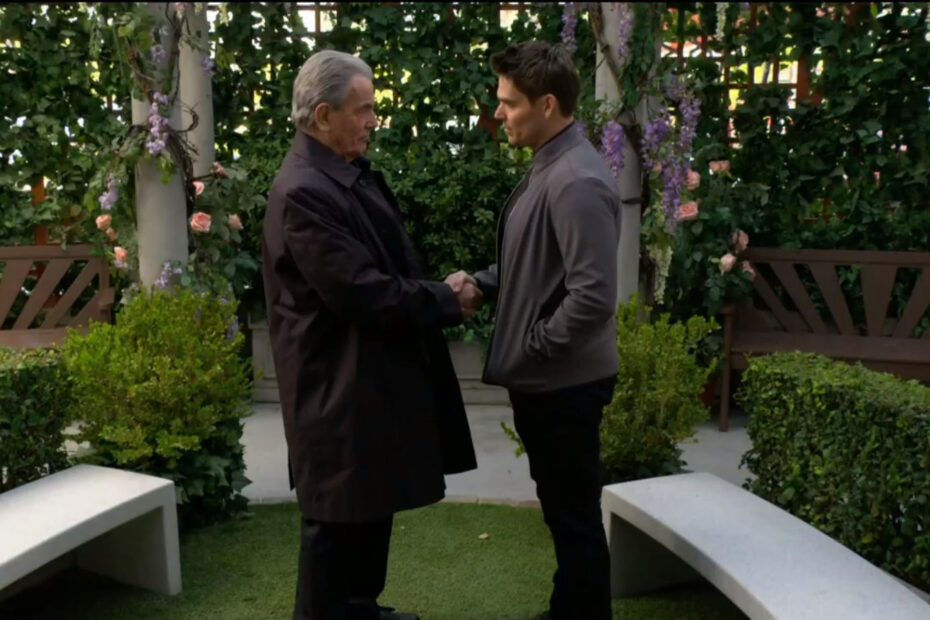 Victor and Adam shake hands in the park.