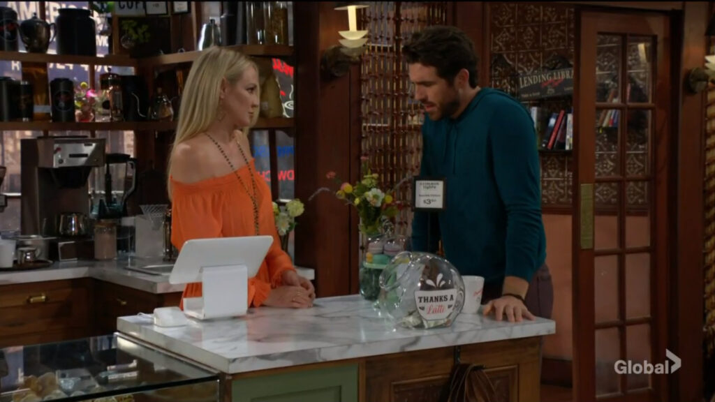 Chance stands at the counter and talks with Sharon.