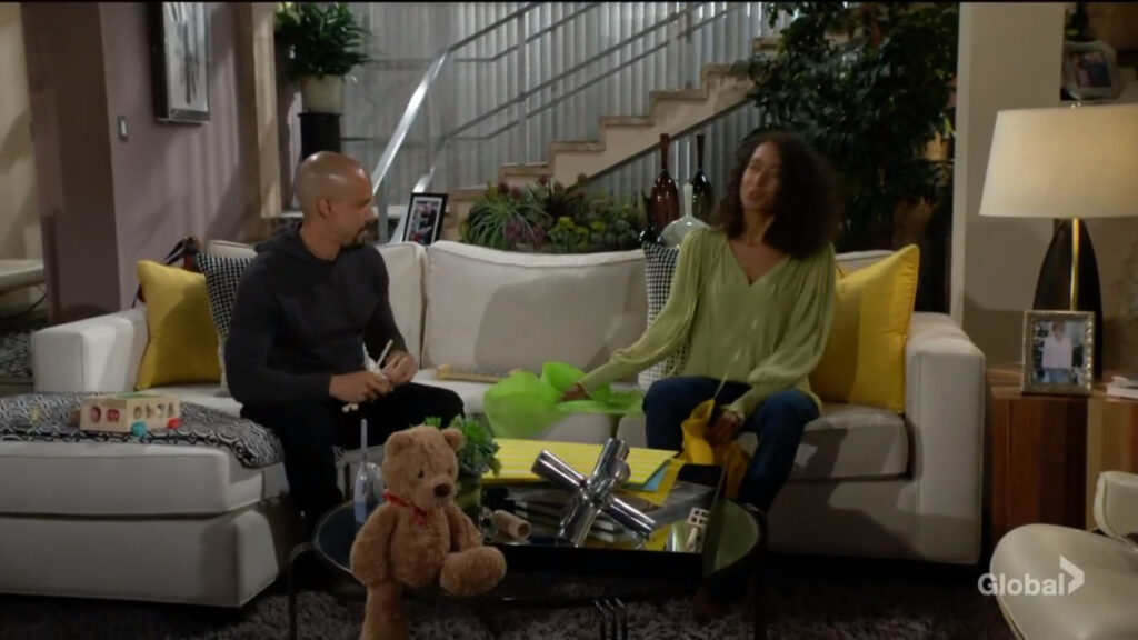 Devon and Harmony sit and talk on the couch, surrounded by toys.
