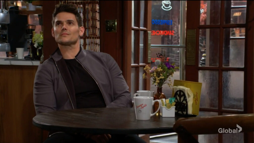Adam blinks away tears as Sally leaves him alone in the coffee shop.
