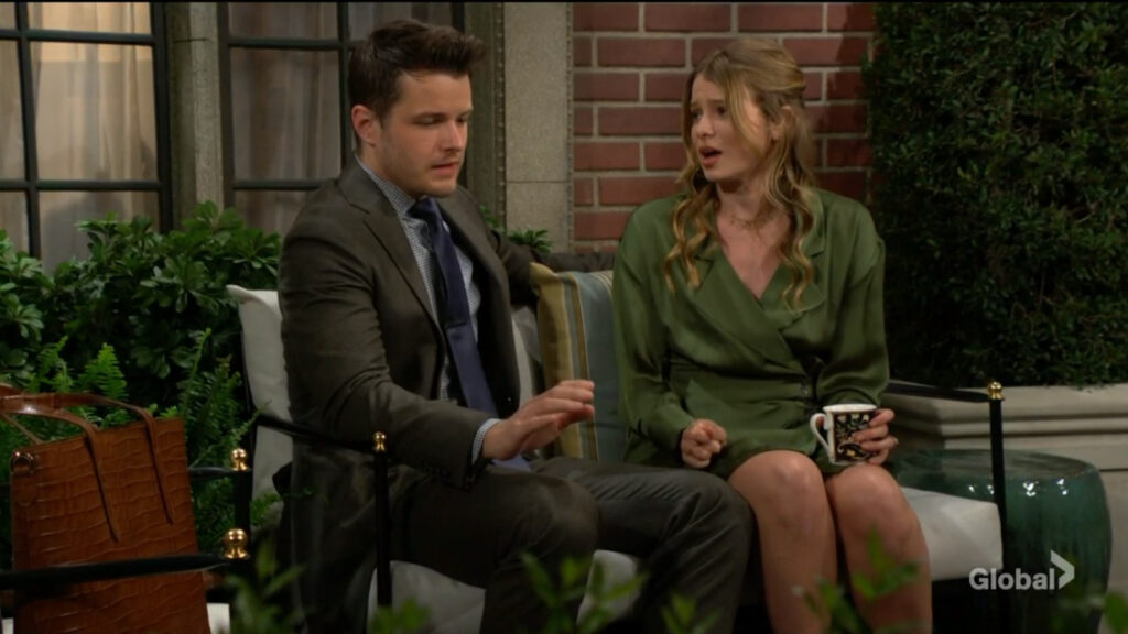 Summer holds a coffee mug as she sits and talks with Kyle.