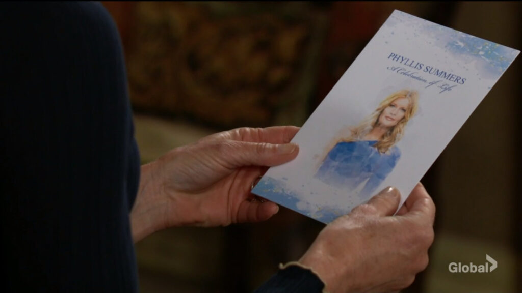 Diane looks at Phyllis's memorial card.