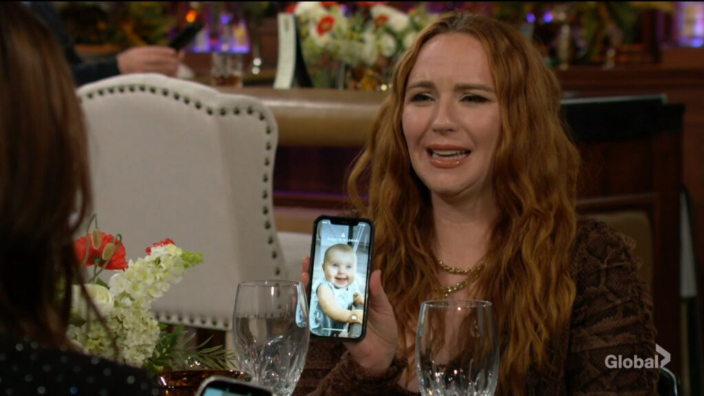 Mariah shows Tessa a picture of baby Aria.