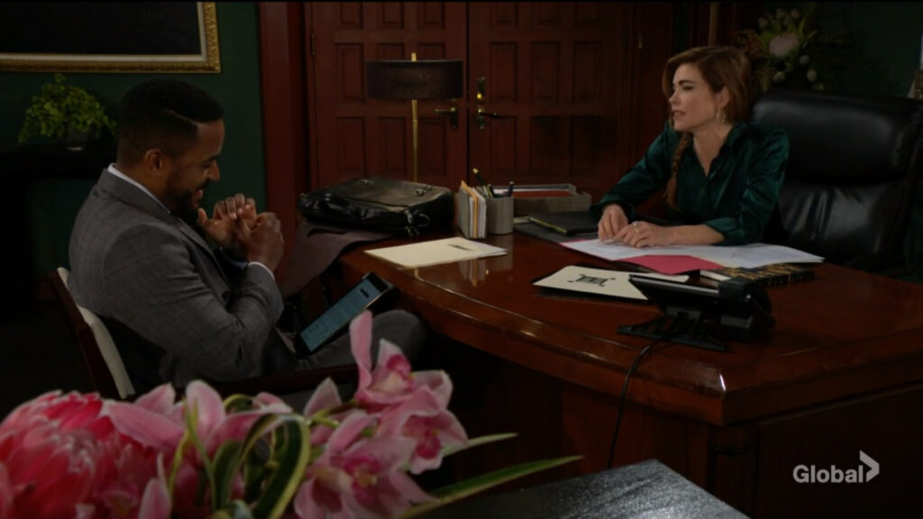 Nate sits with Victoria as they talk in her office.
