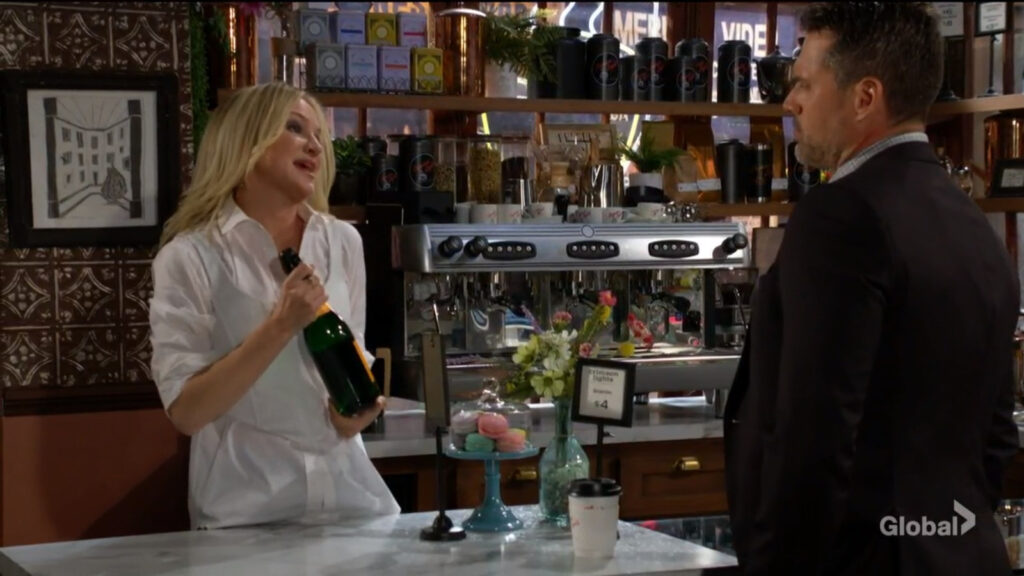 Sharon holds the bottle of champagne as she talks with Nick.