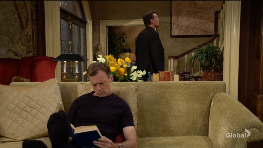 Jack yells for Ashley as Tucker sits on the couch reading.