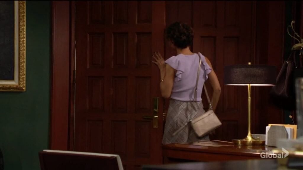 Elena leaves the Newman Enterprise offices.