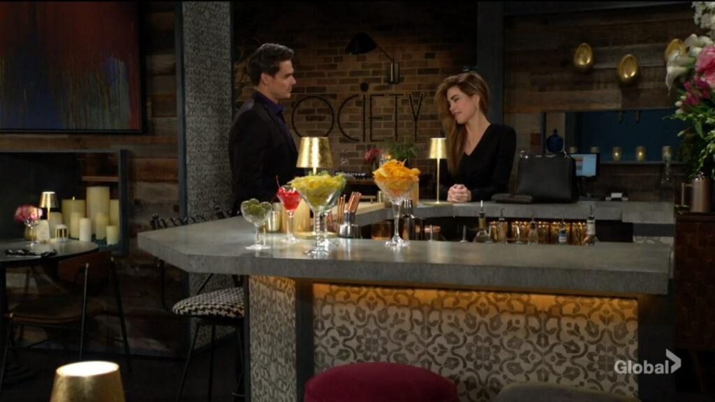 Adam and Victoria talk at the bar in Society.