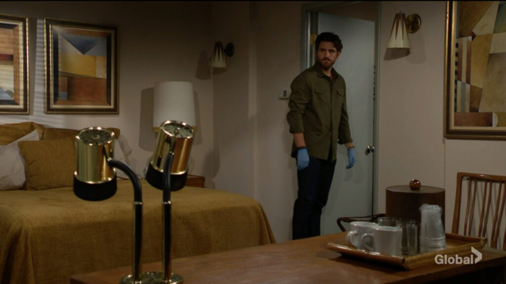 Chance wears blue gloves as he searches the motel room.