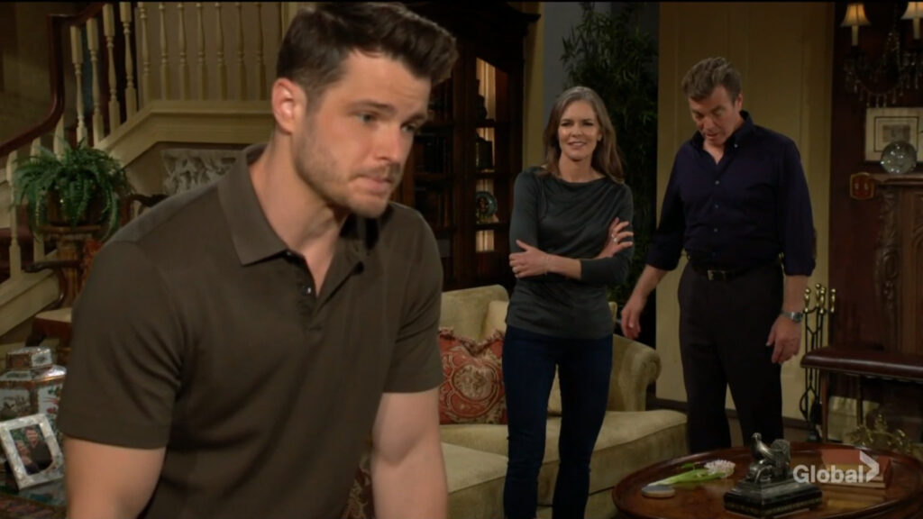 Kyle leans on a table as Diane talks to him as Jack looks on.
