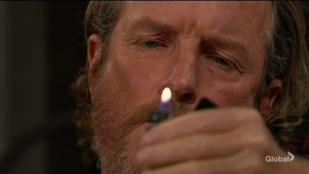 Cameron stares into the lighter's flame.