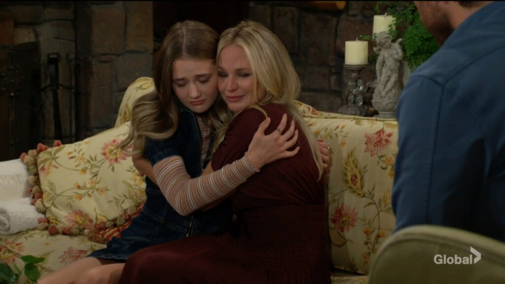 Sharon hugs Faith as Chance looks on.