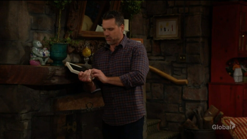 Nick finds a bug behind a photo on Sharon's mantle.